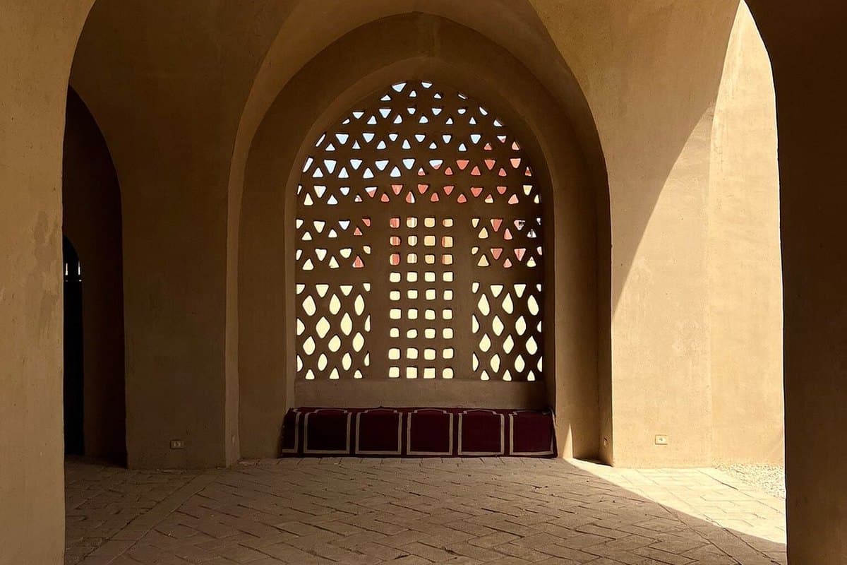 A shaded vaulted passageway and carved plaster screen in traditional mudbrick architecture on Luxor's West Bank